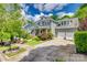 Charming gray home with a front porch, manicured landscaping, and two-car garage at 5518 Morris Hunt Dr, Fort Mill, SC 29708