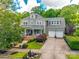 Beautiful gray home showcasing the front yard, covered porch, and manicured landscaping at 5518 Morris Hunt Dr, Fort Mill, SC 29708