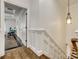 Hallway featuring hardwood flooring, modern lighting, and white molding, leading to the bedrooms at 5518 Morris Hunt Dr, Fort Mill, SC 29708