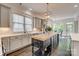 Well-lit kitchen with a large island, stainless steel appliances, white countertops, and ample storage space at 5518 Morris Hunt Dr, Fort Mill, SC 29708