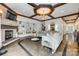 Inviting living room featuring a stone fireplace, built-in shelving, and hardwood floors at 5518 Morris Hunt Dr, Fort Mill, SC 29708