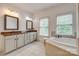 Large bathroom with dual sinks, tub, and tiled shower enclosure at 5518 Morris Hunt Dr, Fort Mill, SC 29708