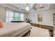 Bright main bedroom features a tray ceiling, chandelier and ensuite bathroom access at 5518 Morris Hunt Dr, Fort Mill, SC 29708
