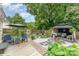 Well landscaped backyard featuring an outdoor patio, seating, a gazebo, and a grilling area at 5829 Andrew Ward Ave, Charlotte, NC 28216