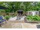 Landscaped backyard featuring a gazebo, shed, and mature trees perfect for outdoor living at 5829 Andrew Ward Ave, Charlotte, NC 28216