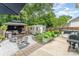 Landscaped backyard featuring a gazebo, shed, fire pit, and barbecue area for outdoor gatherings at 5829 Andrew Ward Ave, Charlotte, NC 28216