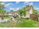Backyard featuring patio, garden area, mature tree, and privacy fence at 5829 Andrew Ward Ave, Charlotte, NC 28216