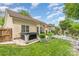 View of a backyard featuring a hot tub, lush landscaping, and outdoor entertaining area under a bright blue sky at 5829 Andrew Ward Ave, Charlotte, NC 28216