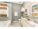 Bright bathroom featuring double sink, granite countertops, herringbone tile floor, and ample storage space at 5829 Andrew Ward Ave, Charlotte, NC 28216