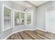 Bright breakfast nook with plenty of natural light from the bay window and new wood-style floors at 5829 Andrew Ward Ave, Charlotte, NC 28216