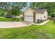 Side view of house with paved driveway leading to a two-car garage and well-maintained landscaping at 5829 Andrew Ward Ave, Charlotte, NC 28216