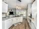 Spacious kitchen featuring white cabinetry, stainless steel appliances, and seamless flow to the living area at 5829 Andrew Ward Ave, Charlotte, NC 28216