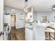 Open kitchen with white cabinets, a breakfast bar, and modern lighting fixtures at 5829 Andrew Ward Ave, Charlotte, NC 28216