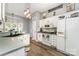 Bright kitchen with white cabinets, modern appliances, and stylish pendant lighting over the island at 5829 Andrew Ward Ave, Charlotte, NC 28216