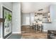 Inviting living room featuring an open layout with modern light fixtures and wood-look floors at 5829 Andrew Ward Ave, Charlotte, NC 28216