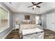 Spacious main bedroom with a tray ceiling, comfortable bed, and natural light at 5829 Andrew Ward Ave, Charlotte, NC 28216