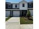 New construction two story townhouse with light gray siding, white trim and white garage door at 6122 Starview Ter, Charlotte, NC 28216