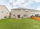 A level backyard with a grassy lawn, patio, and privacy fence at 6532 Prosperity Commons Dr, Charlotte, NC 28269