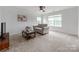 Bright bedroom with neutral carpet, a ceiling fan, and large windows at 6532 Prosperity Commons Dr, Charlotte, NC 28269