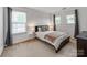 Well-lit bedroom offers carpeted floors and natural light, providing a serene retreat at 6532 Prosperity Commons Dr, Charlotte, NC 28269