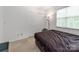 Cozy bedroom with natural light, neutral tones, a futon, and closet at 6532 Prosperity Commons Dr, Charlotte, NC 28269