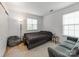 Cozy bedroom with natural light, neutral tones, a futon, and a comfortable seating area at 6532 Prosperity Commons Dr, Charlotte, NC 28269