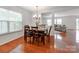 Bright dining area featuring hardwood floors, a chandelier, and a view into the living room at 6532 Prosperity Commons Dr, Charlotte, NC 28269