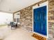 Cozy covered porch with stone detail, seating, and a charming 'Home Sweet Home' welcome mat at 6532 Prosperity Commons Dr, Charlotte, NC 28269