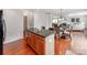 Kitchen with island seating opens to dining area and bright living room at 6532 Prosperity Commons Dr, Charlotte, NC 28269