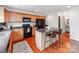 Kitchen features a central island with seating and modern black appliances at 6532 Prosperity Commons Dr, Charlotte, NC 28269