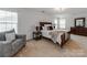 Spacious main bedroom with ample natural light, a large bed, and warm, inviting decor at 6532 Prosperity Commons Dr, Charlotte, NC 28269