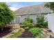This backyard patio offers relaxation with lush landscaping and a stone walkway leading to a cozy outdoor space at 7130 Maricopa Rd, Charlotte, NC 28277