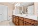 Bathroom featuring a double vanity with white countertops and wood cabinets at 7130 Maricopa Rd, Charlotte, NC 28277