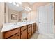 Bright bathroom features dual sinks, framed mirrors, and wood cabinetry at 7130 Maricopa Rd, Charlotte, NC 28277