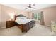 Cozy bedroom featuring a decorative ceiling fan and a large window at 7130 Maricopa Rd, Charlotte, NC 28277