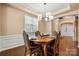 Charming dining area offers hardwood floors, a stylish chandelier, and views of the entryway and staircase at 7130 Maricopa Rd, Charlotte, NC 28277