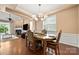Elegant dining room features a modern chandelier, hardwood floors, and ample natural light from the large windows at 7130 Maricopa Rd, Charlotte, NC 28277