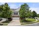 Charming home with a two-car garage framed by mature trees and a well-kept lawn, enhancing curb appeal at 7130 Maricopa Rd, Charlotte, NC 28277