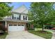 Charming two-story home featuring a two-car garage, stone accents, and a well-maintained lawn with lush landscaping at 7130 Maricopa Rd, Charlotte, NC 28277