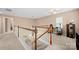 Upstairs hallway featuring neutral colors and staircase at 7130 Maricopa Rd, Charlotte, NC 28277