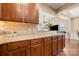 Kitchen counter overlooking the adjacent room, featuring granite countertops and wooden cabinets at 7130 Maricopa Rd, Charlotte, NC 28277