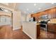 Bright kitchen with stainless steel appliances, wood cabinets, and granite countertops at 7130 Maricopa Rd, Charlotte, NC 28277