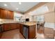 Kitchen with stainless steel appliances and wood cabinets that opens to dining area at 7130 Maricopa Rd, Charlotte, NC 28277