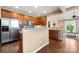 Kitchen featuring stainless steel appliances, wood cabinets, granite countertops, and hardwood floors at 7130 Maricopa Rd, Charlotte, NC 28277