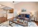 Relaxing living space featuring a cozy couch, hardwood floors, and an open view to the kitchen at 7130 Maricopa Rd, Charlotte, NC 28277
