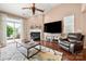 Bright and cozy living room featuring a fireplace, vaulted ceiling, and a sliding door to the backyard at 7130 Maricopa Rd, Charlotte, NC 28277