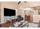 Comfortable living room with high ceilings, hardwood floors, a fireplace, and an open view to the dining area at 7130 Maricopa Rd, Charlotte, NC 28277