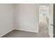 Hallway with neutral walls, plush carpet, and open doorway, creating a welcoming and airy space at 741 Laguna Ave, York, SC 29745