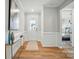Welcoming entryway featuring hardwood floors, wainscoting, and natural light at 9930 Cask Way, Huntersville, NC 28078