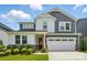Charming two-story home featuring a red front door, white siding, gray accents and a two-car garage at 9930 Cask Way, Huntersville, NC 28078